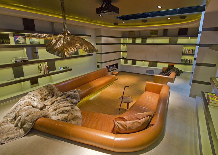The basement houses a chestnut leather sunken conversation pit and adjacent bar for watching movies.