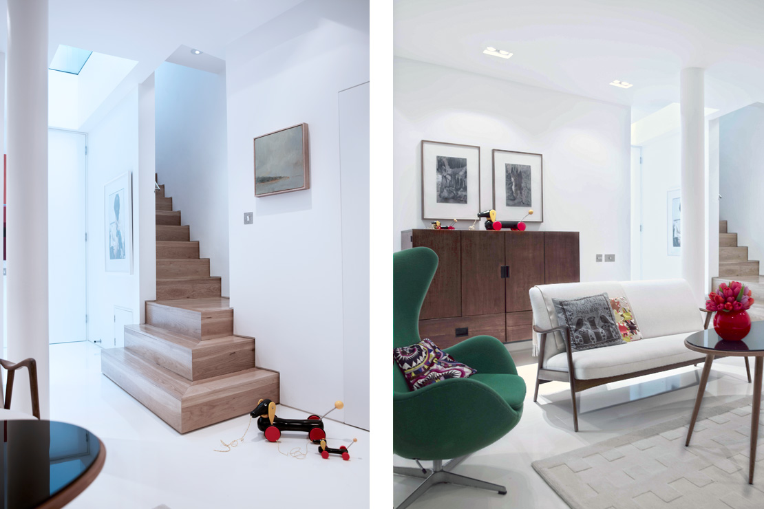 Natural light pours through a glass floor in the kitchen into a basement playroom with white resin floors below.