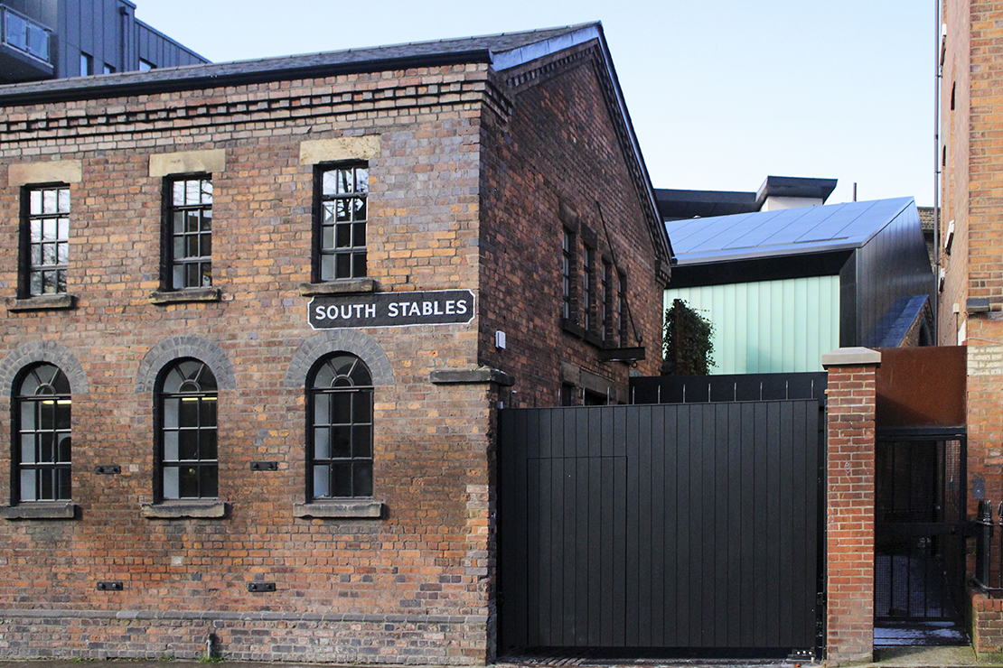 A momentary glimpse from the street of the steel and glass house at the rear of the site.