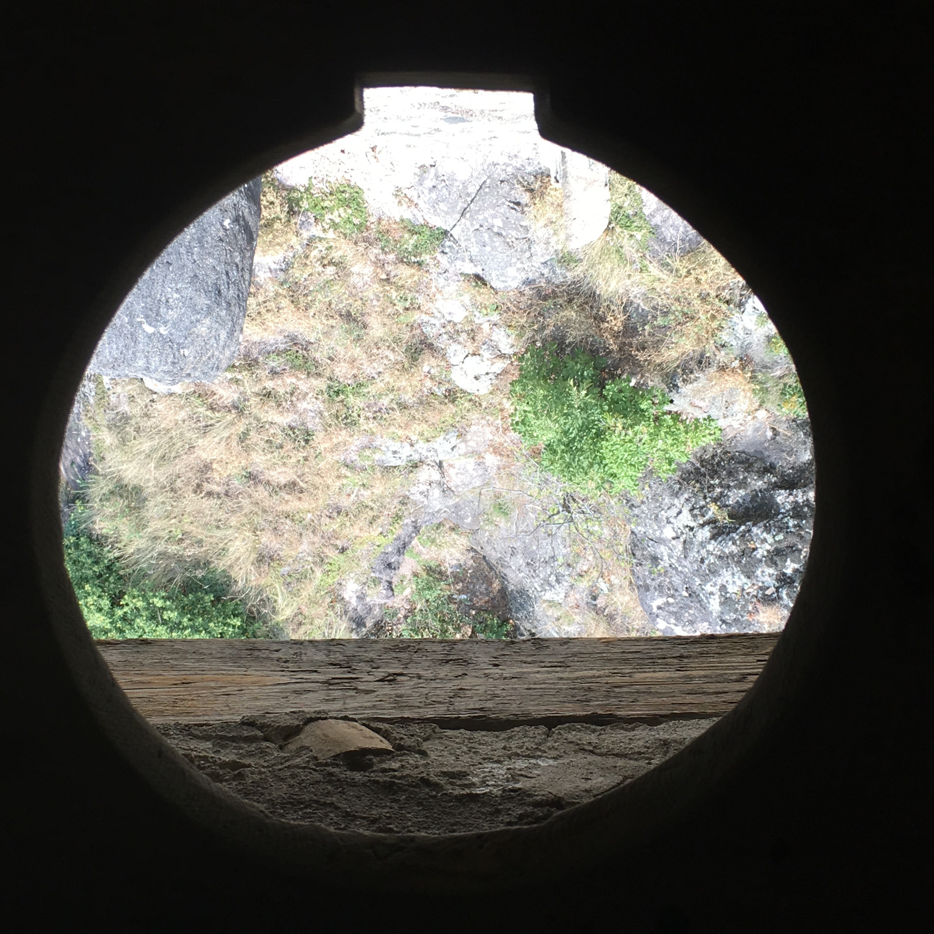 Medieval stone WC cantilevering over the perimeter walls to the cliffs below.