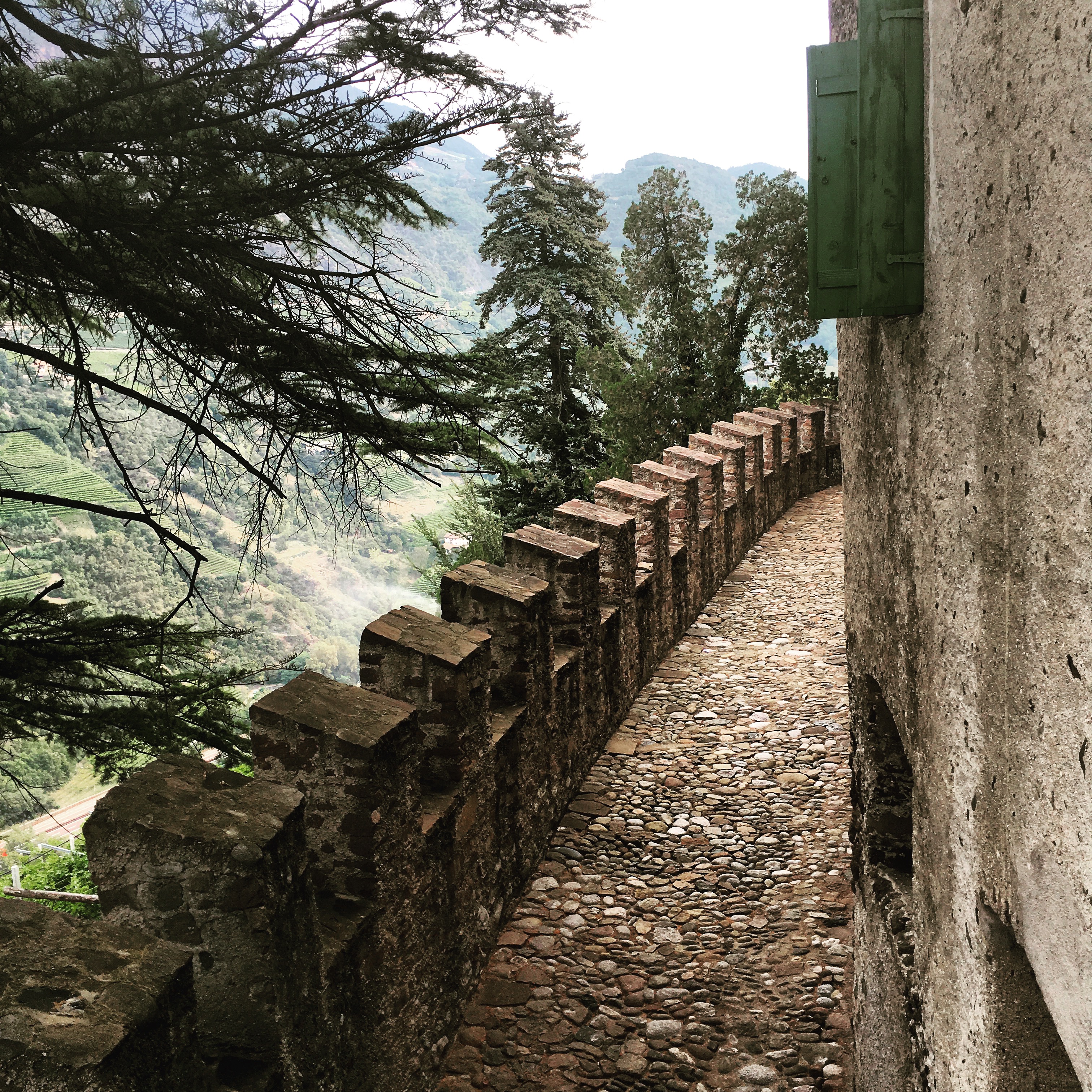 View from a bedroom over the castellated walls to the valley beyond.