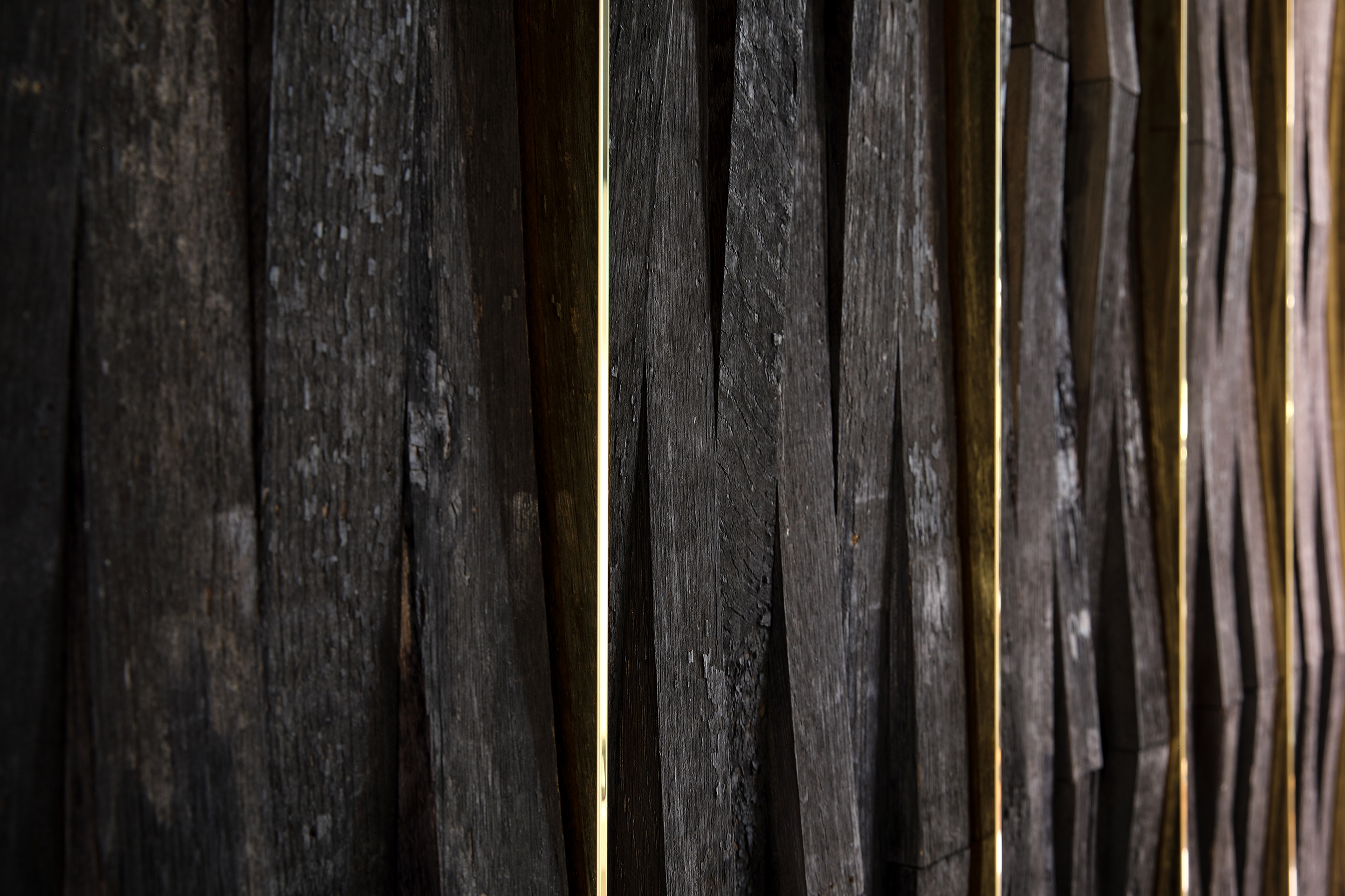 Original charred barrel staves (complete with the authentic aroma of fermented whisky) were shipped from a cooperage in Scotland to clad the walls.