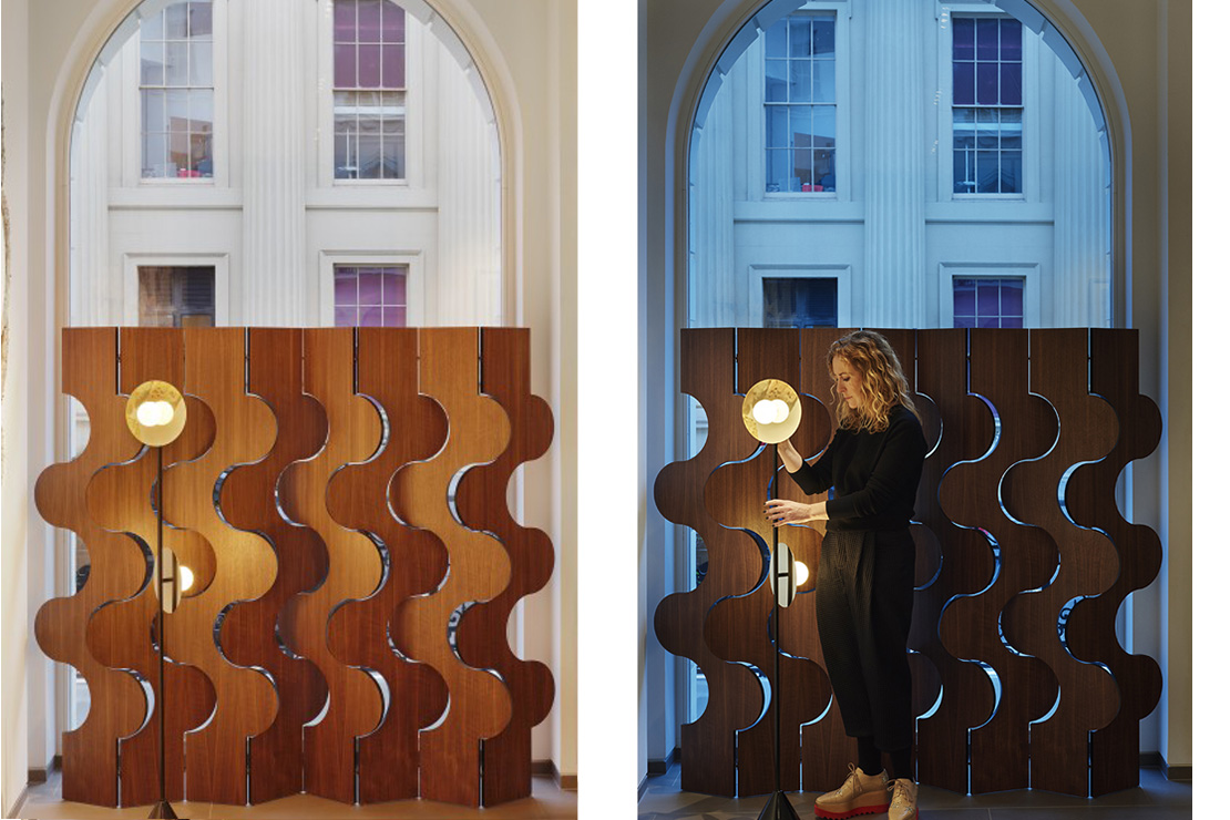 Walnut screens against the windows provide privacy from the street but allow shafts of light into the hall and opening the articulated panels offers momentary views to the outside. 