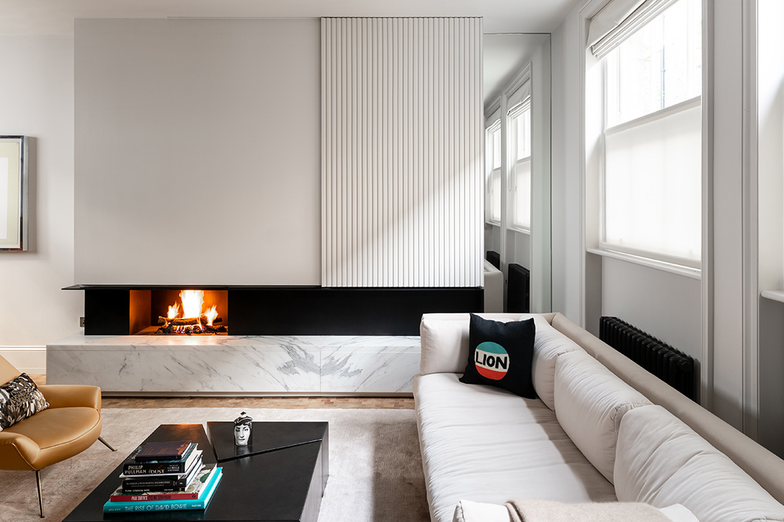 A sliding panel above the fire in the living room can be opened to reveal a library of vinyl records.