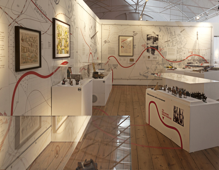 In this section strategic war maps lined the walls and plinths for models were formed with topographical  contours and placed around the gallery space.  An interactive bunker for children's play supported a watch tower from which the beam of a search tower patrolled the landscape.