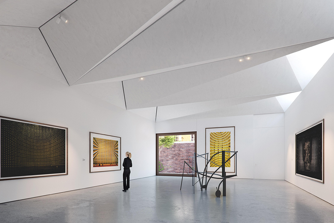 Visual of the main gallery space with origami folded roof at ground floor level with external sculpture courtyard.