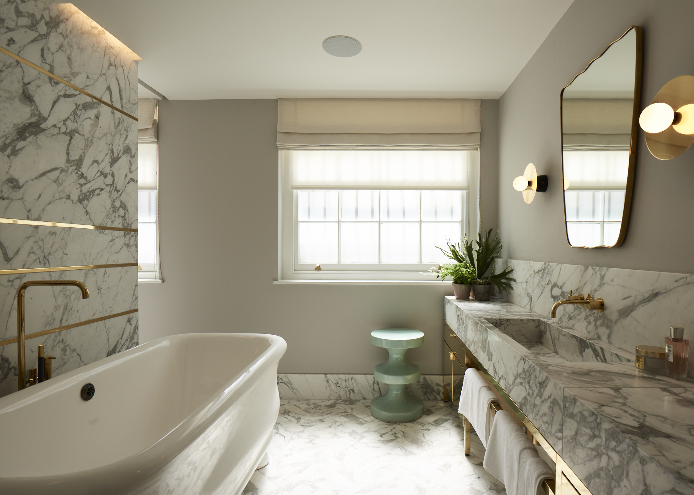 The master bathroom is clad in Arabascato marble with inlaid brass.