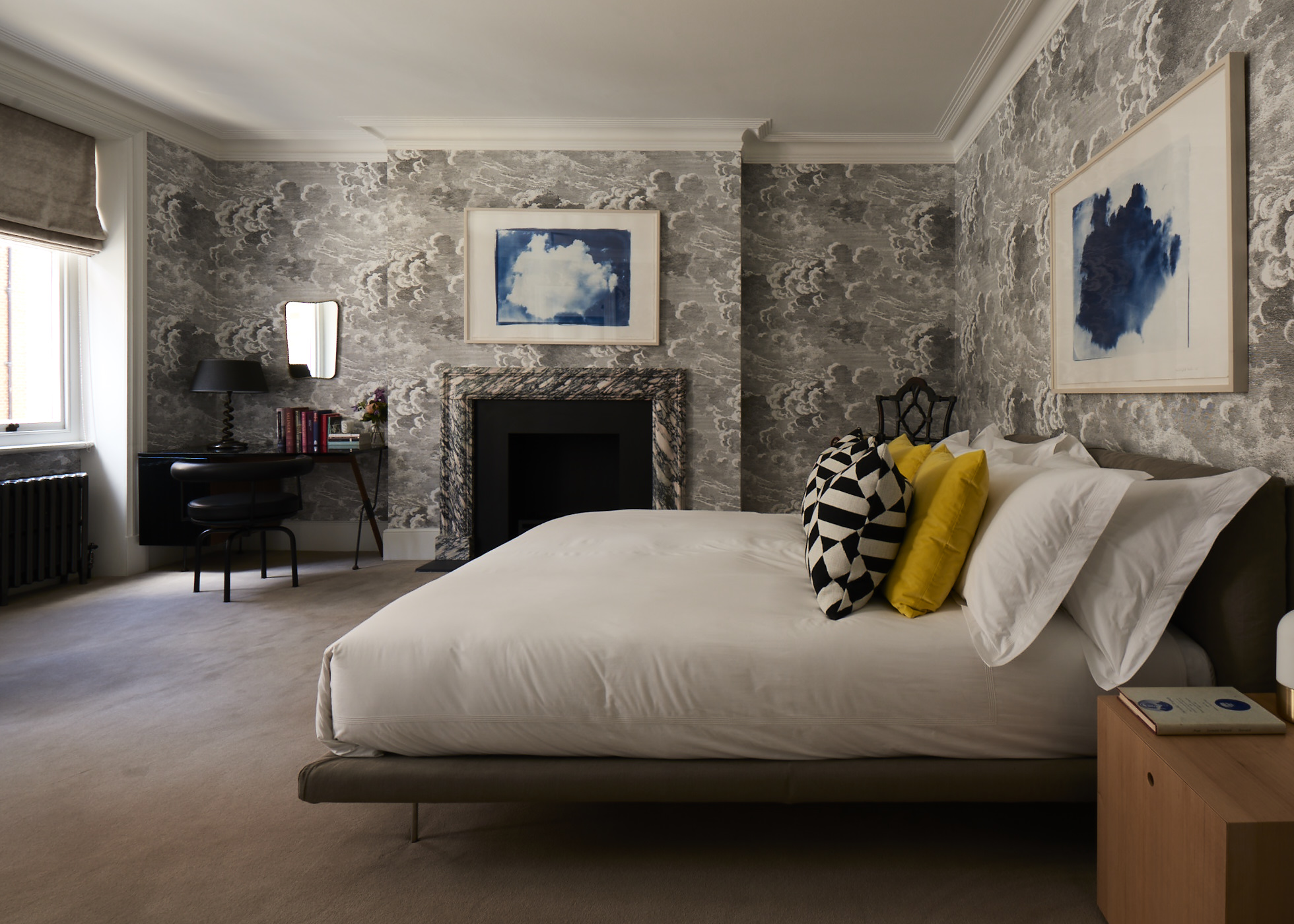 The guest bedroom with clouds wallpaper by Piero Fornasetti. 