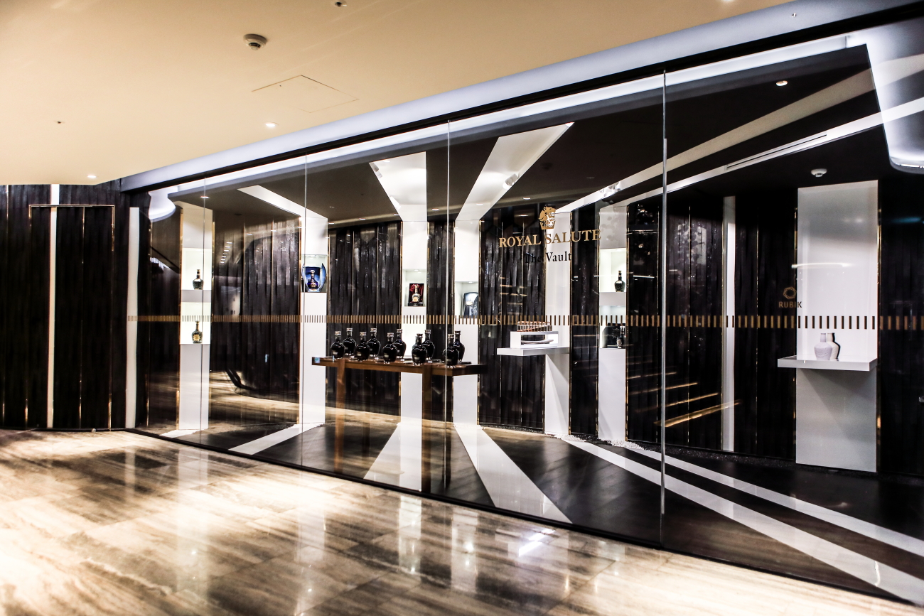Dramatic monochromatic lines of white porcelain and black charred timber draw visitors into the tasting showroom. 