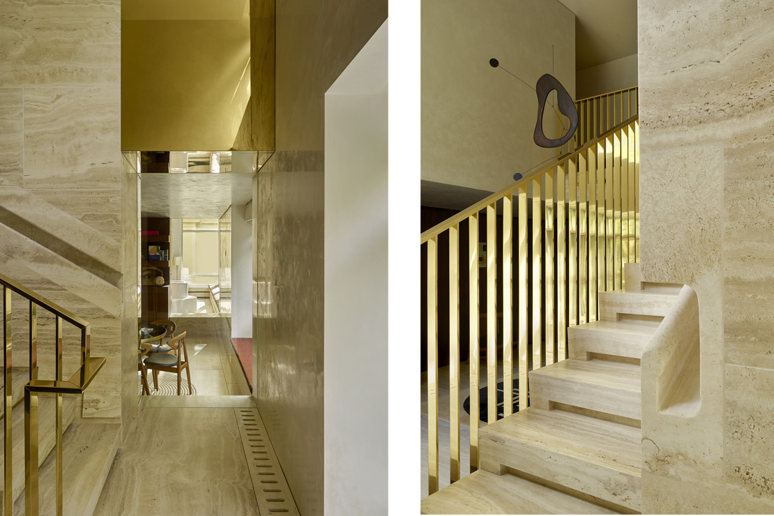 The entrance hall features a custom staircase with recessed handrail from a solid slab of travertine